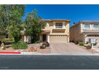 Charming two-story home with a well-maintained front yard and a paved driveway on a sunny day at 10908 Royal Highlands St, Las Vegas, NV 89141