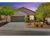 Charming single-story home with a two-car garage and well-manicured landscaping at 11764 Golden Moments Ave, Las Vegas, NV 89138
