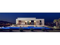 Stunning modern home featuring a sleek pool with an incredible outdoor living space and city views at 1204 Powerwall Pl, Henderson, NV 89012