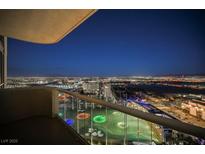 Expansive balcony view overlooking the city and Topgolf, with a glass railing, for seamless enjoyment at 135 E Harmon Ave # 2420, Las Vegas, NV 89109