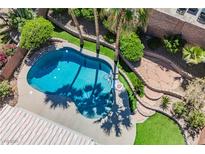 Aerial view of backyard pool featuring rock landscaping and ample patio space at 209 Camino Vista St, Henderson, NV 89012