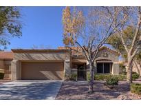 Charming single-story home featuring desert landscaping, a two-car garage, and a welcoming front entrance at 2437 Desert Butte Dr, Las Vegas, NV 89134