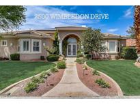 Charming single-story home with a well-manicured front yard and a welcoming arched entryway at 2500 Wimbledon Dr, Las Vegas, NV 89107