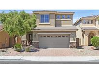 Two-story home featuring a neutral color scheme, a two-car garage, and well-manicured landscaping at 2864 Kinknockie Way, Henderson, NV 89044