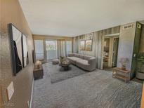 Cozy living room features neutral colors, balcony access and contemporary furnishings at 2867 Geary Pl # 3008, Las Vegas, NV 89109