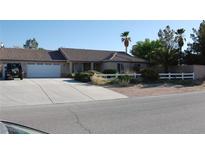 Charming single-story home featuring a well-manicured front yard and a spacious driveway at 30 Diamond Bar Rd, Pahrump, NV 89048