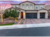 Beautiful two-story home featuring a two-car garage and professionally landscaped front yard with charming walkway lighting at 3929 Reyes Ave, Las Vegas, NV 89141