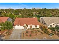 Charming home featuring a tile roof and mature trees on a well-maintained lot at 5020 Linkside Dr, Las Vegas, NV 89130