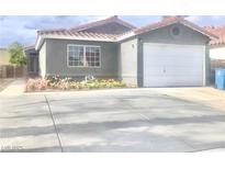 Charming single-story home with a well-maintained lawn and a two-car garage at 579 Grimsby Ave, Henderson, NV 89014