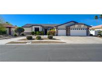 Inviting single-story home with a well-manicured lawn, three-car garage, and mature landscaping at 7461 Tahoe Basin Dr, Las Vegas, NV 89129