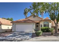 Charming single-story home featuring a terracotta tile roof, two-car garage, and well-maintained landscaping at 8109 Sunset Mill Dr, Las Vegas, NV 89128