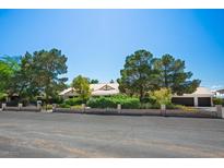 Charming single-story home with mature trees, lush landscaping, and a well-maintained lawn at 8365 S Hauck St, Las Vegas, NV 89139