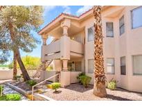 Inviting two-story condo with a private balcony and classic desert landscaping at 904 Boulder Springs Dr # 102, Las Vegas, NV 89128