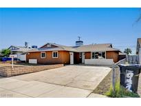 Charming single-story home with an expansive driveway, xeriscaping, and lush landscaping at 929 Center St, Henderson, NV 89015