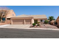 Attractive single-story home featuring a two-car garage and desert landscaping in front at 945 Stetson Dr, Henderson, NV 89002