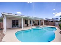 Backyard features a refreshing pool with a covered patio, perfect for relaxing and entertaining at 967 Cardelina Ln, Henderson, NV 89052