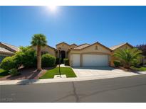 Charming single-story home boasts a well-manicured lawn, desert landscaping, and an attached two-car garage at 10645 Alpine Frost Ct, Las Vegas, NV 89129