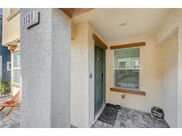 Inviting front entry featuring a green door, welcome mat, and textured columns at 1131 Ruby Sparrow St, Henderson, NV 89011
