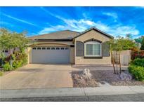 Charming single-story home featuring a well-manicured front yard and a two-car garage at 11441 Drappo Ave, Las Vegas, NV 89138