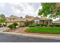 Charming single-story home with a lush, green lawn, mature landscaping, and a welcoming facade at 1704 River Birch St, Las Vegas, NV 89117