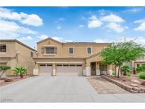 Charming two-story home featuring a three car garage, desert landscaping, and covered front entryway at 1808 Peyton Stewart Ct, North Las Vegas, NV 89086