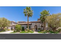 Charming home with lush landscaping and mature palm trees in a sunny, vibrant neighborhood at 2436 Grassy Spring Pl, Las Vegas, NV 89135