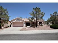 Charming single-story home featuring a two-car garage, tile roof, and desert landscaping at 2820 Bluff Point Dr, Las Vegas, NV 89134