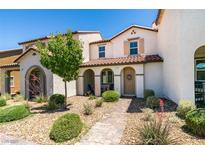 Charming townhome with landscaped front yard and covered porch entry way at 2870 Turnstone Ridge St, Henderson, NV 89044