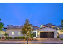Charming single-story home featuring manicured landscaping, warm brick driveway, and a two-car garage at 3020 Via Venezia, Henderson, NV 89052