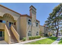 View of the building's exterior featuring a staircase leading to the upper levels and well-maintained landscaping at 3145 E Flamingo Rd # 2080, Las Vegas, NV 89121