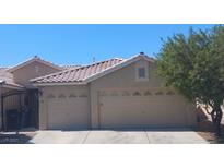 Charming single-Gathering home with tile roof and two-car garage, showcasing curb appeal at 3521 Amish Ave, North Las Vegas, NV 89031