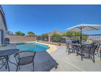 Relaxing backyard pool with mountain views and patio seating, perfect for outdoor entertaining at 4020 Driscoll Mountain St, Las Vegas, NV 89129