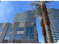 Modern high-rise building featuring a sleek facade, palm trees, and a blue sky backdrop at 4575 Dean Martin Dr # 3206, Las Vegas, NV 89103