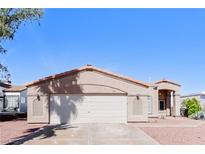 Charming single-story home with a two-car garage, desert landscaping, and a well-maintained front yard at 472 Tiger Lily Way, Henderson, NV 89015