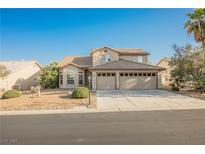 Two-story home featuring a two-car garage and desert landscaping at 5133 Burr Oak Dr, Las Vegas, NV 89130