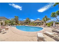 Enjoy the community pool with comfortable lounge chairs under the sunny blue sky at 5710 E Tropicana Ave # 1114, Las Vegas, NV 89122