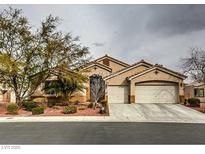 Charming single-story home featuring a well-manicured front yard and a two-car garage at 6712 Tattler Dr, North Las Vegas, NV 89084