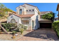 Charming two-story home with stucco siding, a red tile roof, and a brick driveway and desert landscaping at 8159 Base Camp Ave, Las Vegas, NV 89178