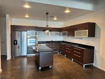 Modern kitchen boasts stainless steel appliances, dark wood cabinetry, and a center island at 900 Las Vegas Blvd # 1003, Las Vegas, NV 89101