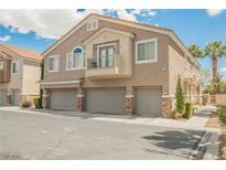 Inviting stucco townhome with three-car garage and charming balcony perfect for relaxing at 9490 Thunder Sky St # 102, Las Vegas, NV 89178
