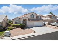 Charming two-story home with a well-maintained yard, two-car garage, and classic desert landscaping at 9785 Turtle Head Ct, Las Vegas, NV 89117