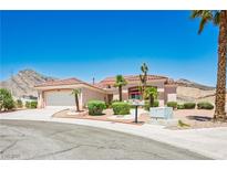 Charming single-story home with a tile roof, desert landscaping, and an attached two-car garage at 10720 Bennington Ct, Las Vegas, NV 89134