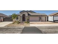 Charming home features a two-car garage and an RV garage, complemented by tasteful stone accents at 130 W Fairway Rd, Henderson, NV 89015