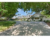 Beautiful home with lush landscaping, mature trees, and long driveway perfect for entertaining at 204 Canyon Dr, Las Vegas, NV 89107