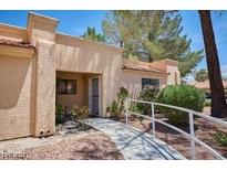 Single-story home featuring a stucco exterior, red tile roof, and a paved walkway leading to the front door at 2851 S Valley View Blvd # 1199, Las Vegas, NV 89102