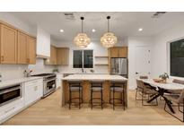 Modern kitchen featuring a large island, stainless steel appliances, and stylish pendant lighting at 2921 Guillemot Ave, North Las Vegas, NV 89084