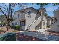 Inviting condo with desert landscaping, stairs to the unit, and neutral color palette at 3103 Key Largo Dr # 103, Las Vegas, NV 89120