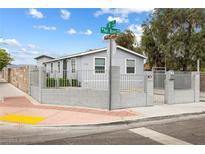 Charming single-story home featuring a secure fenced yard, freshly painted exterior, and manicured landscaping at 320 W Van Buren Ave, Las Vegas, NV 89106