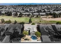 An aerial view of single-story home with desert landscaping and golf course, set within a suburban neighborhood at 3405 Kingbird Dr, North Las Vegas, NV 89084