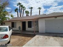 Modest one-story home with brick accents, covered front porch, and a single-car attached garage at 45 Logan Ct, Las Vegas, NV 89110